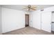 Bedroom with ceiling fan, neutral decor, and access to a bathroom at 3127 W Folgers Rd, Phoenix, AZ 85027