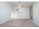 Bright bedroom with ceiling fan and neutral carpeting at 3127 W Folgers Rd, Phoenix, AZ 85027