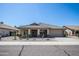 Tan one-story house with a two-car garage and desert landscaping at 3127 W Folgers Rd, Phoenix, AZ 85027