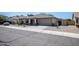 One-story house with a two-car garage, cacti, and gravel driveway at 3127 W Folgers Rd, Phoenix, AZ 85027