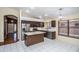 Kitchen with an island, stainless steel appliances, and dark wood cabinets at 3127 W Folgers Rd, Phoenix, AZ 85027