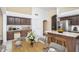 Bright kitchen featuring white tile floors, ample cabinets, and stainless steel appliances at 3127 W Folgers Rd, Phoenix, AZ 85027