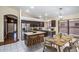 Eat-in kitchen with stainless appliances, a central island, and modern light fixture over dining table at 3127 W Folgers Rd, Phoenix, AZ 85027