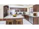 Updated kitchen with stainless steel appliances, an island with barstool seating, and modern cabinetry at 3127 W Folgers Rd, Phoenix, AZ 85027