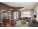 Inviting living room featuring hardwood floors, a vaulted ceiling, neutral paint, and modern decor at 3127 W Folgers Rd, Phoenix, AZ 85027