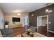 Cozy living room with hardwood floors, chic decor, modern lighting, and neutral paint at 3127 W Folgers Rd, Phoenix, AZ 85027