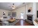 Comfortable living room with high ceilings, a cozy fireplace, lots of natural light, and neutral colors at 3127 W Folgers Rd, Phoenix, AZ 85027