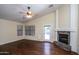 Living room with fireplace, hardwood floors, and access to backyard at 3127 W Folgers Rd, Phoenix, AZ 85027