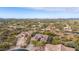 Aerial view of a residential neighborhood showcasing a large house with a desert landscape at 32032 N 52Nd Way, Cave Creek, AZ 85331