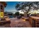 Evening view of backyard with pool, spa, and outdoor kitchen at 32032 N 52Nd Way, Cave Creek, AZ 85331