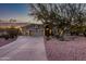 Beautiful home exterior with a three-car garage and desert landscaping at 32032 N 52Nd Way, Cave Creek, AZ 85331