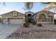 Single story home with a three-car garage and desert landscaping at 32032 N 52Nd Way, Cave Creek, AZ 85331