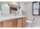 Clean bathroom with light wood cabinets and a skylight at 3301 S Goldfield Rd # 4086, Apache Junction, AZ 85119