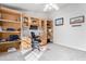 Spacious home office with built-in shelving and desk at 3301 S Goldfield Rd # 4086, Apache Junction, AZ 85119