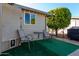 Small patio with table and chairs, artificial turf at 3301 S Goldfield Rd # 4086, Apache Junction, AZ 85119