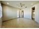 Bedroom with tile floors, ceiling fan, and bathroom access at 3448 E Spring Wheat Ln, Gilbert, AZ 85296