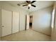 Well-lit bedroom with tile floors and access to another room at 3448 E Spring Wheat Ln, Gilbert, AZ 85296