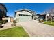 Two story light sage home with a three car garage at 3448 E Spring Wheat Ln, Gilbert, AZ 85296