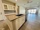 Open kitchen layout with island and view into living room at 3448 E Spring Wheat Ln, Gilbert, AZ 85296