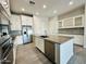 Modern kitchen with island, stainless steel appliances, and white cabinetry at 3448 E Spring Wheat Ln, Gilbert, AZ 85296