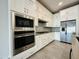 Modern kitchen with stainless steel appliances and white cabinets at 3448 E Spring Wheat Ln, Gilbert, AZ 85296