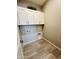 Laundry room with white cabinets and tile floor at 3448 E Spring Wheat Ln, Gilbert, AZ 85296