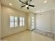 Living room with tile floor, neutral walls, and ceiling fan at 3448 E Spring Wheat Ln, Gilbert, AZ 85296