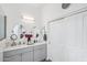 Bathroom with double vanity, gray cabinets, and oval mirrors at 3519 E Red Oak Ln, Gilbert, AZ 85297