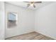 Simple bedroom with ceiling fan, window, and double door closet at 3519 E Red Oak Ln, Gilbert, AZ 85297