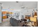 Open living room and kitchen with gray sofas and hardwood floors at 3519 E Red Oak Ln, Gilbert, AZ 85297