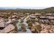 Aerial view of community entrance and homes with pools, desert landscaping, and mountains at 4215 S Willow Springs Trl, Gold Canyon, AZ 85118