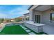 Inviting outdoor space featuring a built-in stone barbecue, stepping stones, lush lawn, and desert landscape at 4215 S Willow Springs Trl, Gold Canyon, AZ 85118