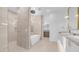 Elegant bathroom featuring double vanity sinks, modern lighting and mirrors, and a free-standing bathtub at 4215 S Willow Springs Trl, Gold Canyon, AZ 85118