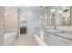 Luxurious bathroom featuring double sinks, modern lighting, and a standalone tub next to the walk-in closet at 4215 S Willow Springs Trl, Gold Canyon, AZ 85118