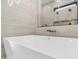 Modern white bathtub with gold fixtures and a view of the shower and a decorative pendant lamp at 4215 S Willow Springs Trl, Gold Canyon, AZ 85118