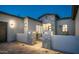 Home entrance featuring stone pillars, accent lighting, and desert landscaping at 4215 S Willow Springs Trl, Gold Canyon, AZ 85118