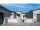 Exterior entrance featuring stone pillars, desert landscaping, and a modern black door at 4215 S Willow Springs Trl, Gold Canyon, AZ 85118