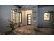 Home entrance with a modern door, stone accents, desert landscaping, and black trim windows at 4215 S Willow Springs Trl, Gold Canyon, AZ 85118