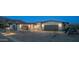 Desert home at night with landscape lighting illuminating the paved driveway and home's facade at 4215 S Willow Springs Trl, Gold Canyon, AZ 85118