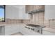 Modern kitchen featuring white cabinets, stainless steel appliances, and neutral backsplash at 4215 S Willow Springs Trl, Gold Canyon, AZ 85118