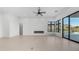 Bright living room with sleek fireplace, ceiling fan, and expansive windows offering beautiful mountain views and a pool at 4215 S Willow Springs Trl, Gold Canyon, AZ 85118