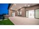 Expansive covered patio with built-in grill, lush turf, and elegant tile flooring for seamless indoor-outdoor living at 4215 S Willow Springs Trl, Gold Canyon, AZ 85118