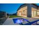 Charming outdoor space with a tranquil pool, patio, and a built-in grill perfect for entertaining, set against desert landscape at 4215 S Willow Springs Trl, Gold Canyon, AZ 85118
