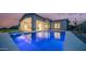 Enjoy a tranquil desert sunset from this home featuring a shimmering swimming pool and relaxing outdoor patio at 4215 S Willow Springs Trl, Gold Canyon, AZ 85118