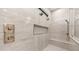 Modern shower with rainfall shower heads, a bench, and a shower niche for storage in the gray-tiled enclosure at 4215 S Willow Springs Trl, Gold Canyon, AZ 85118