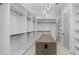 Spacious walk-in closet featuring custom storage, a center island and modern lighting at 4215 S Willow Springs Trl, Gold Canyon, AZ 85118