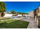 Landscaped backyard with pool, patio, and seating at 4430 E Graythorn St, Phoenix, AZ 85044