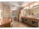 Elegant bathroom with a large soaking tub, double vanity, and stone tile at 4430 E Graythorn St, Phoenix, AZ 85044