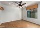 Bright bedroom with cork flooring and ceiling fan at 4430 E Graythorn St, Phoenix, AZ 85044