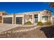 Two-story house with stone accents and a three-car garage at 4430 E Graythorn St, Phoenix, AZ 85044